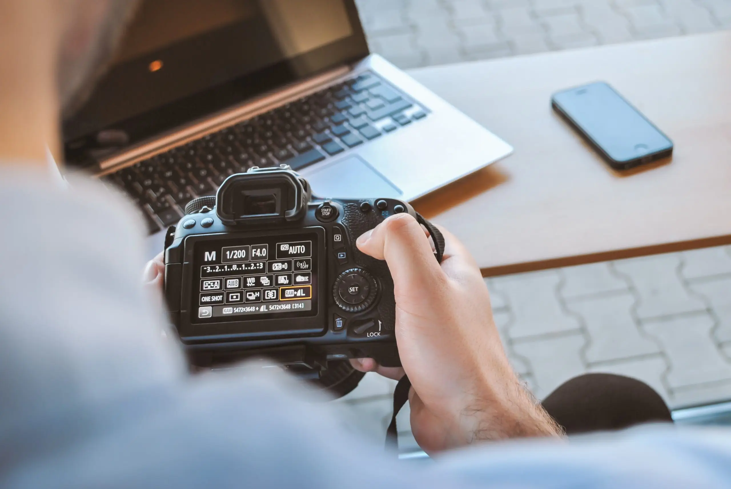 photographer-changing-settings-on-dslr-camera