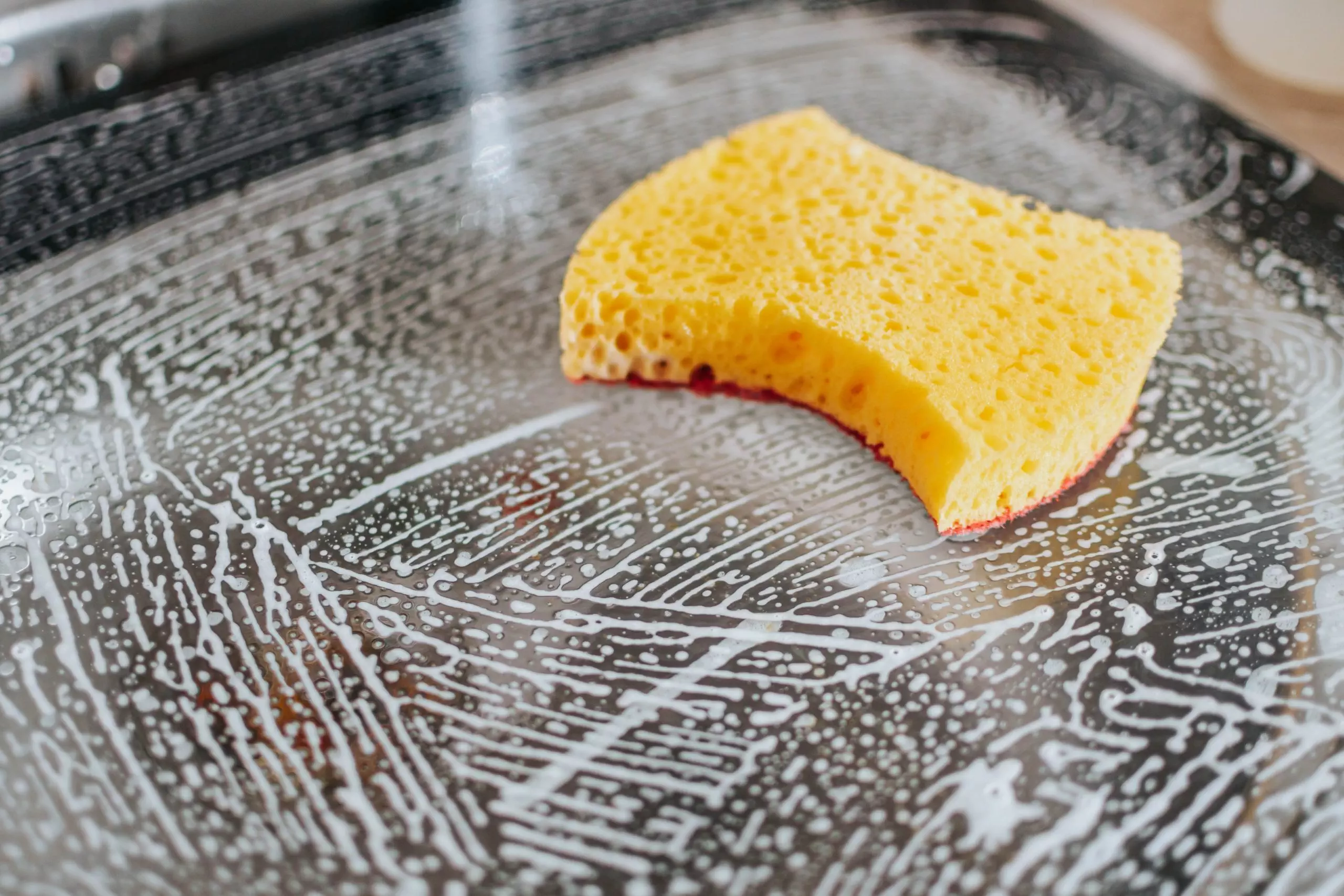 yellow-sponge-cleaning-a-glass-bowl