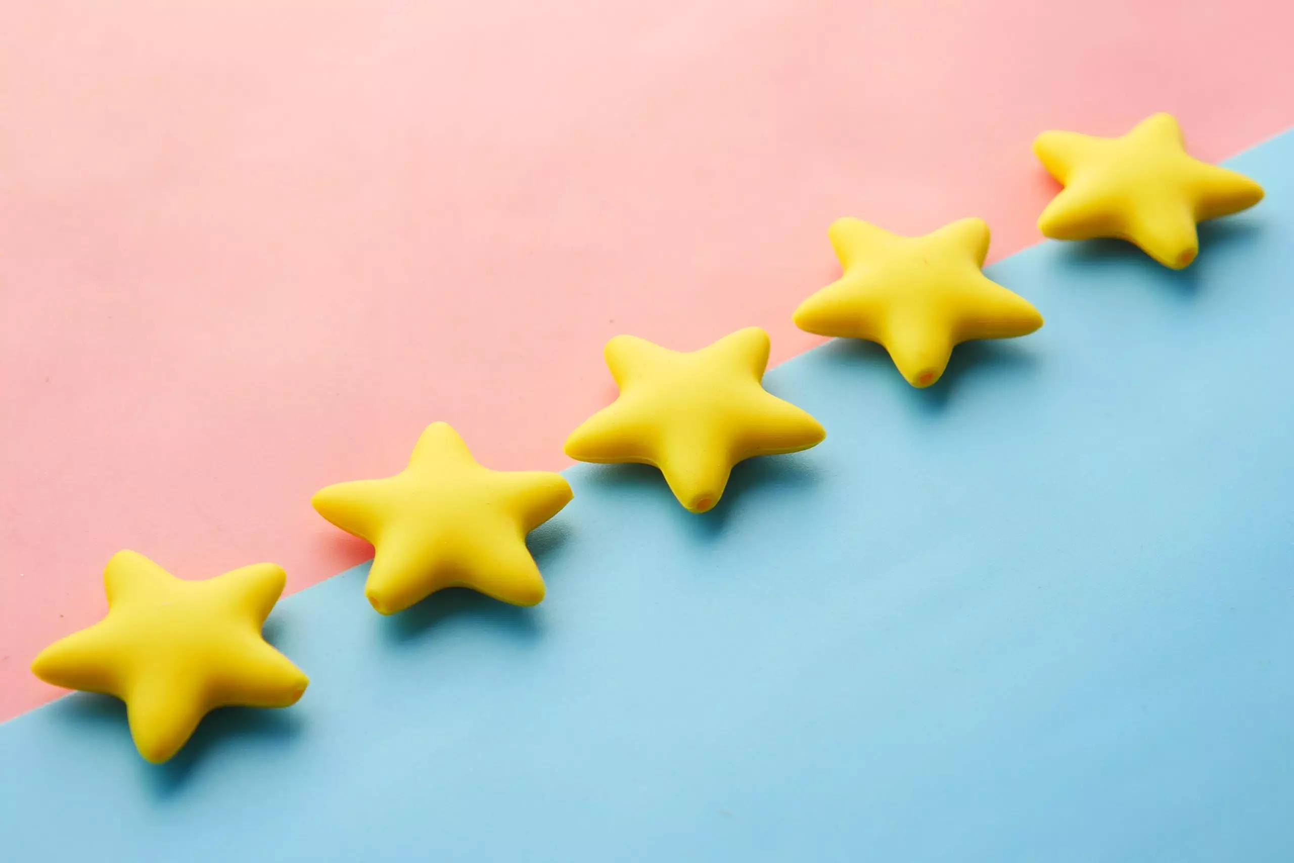 five-yellow-stars-on-a-diagonal-pink-and-blue-background